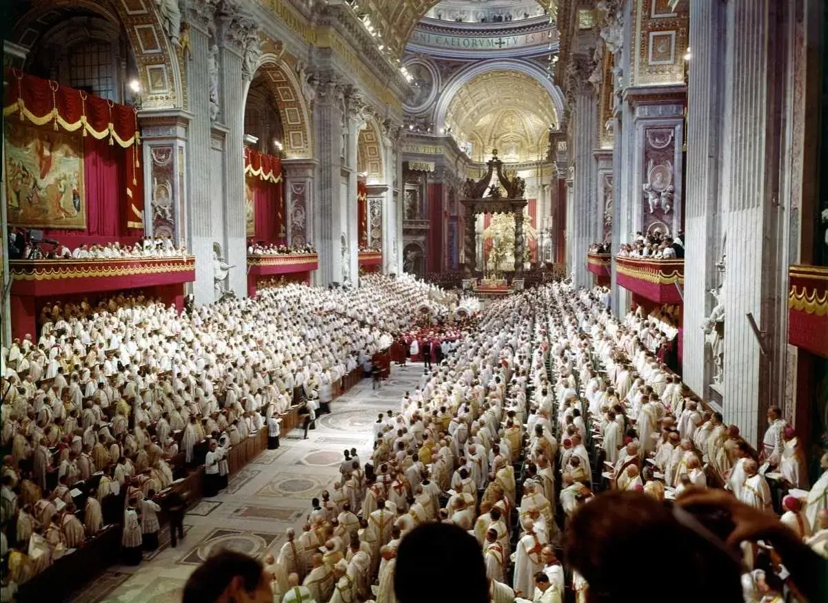 Gro&szlig;e Versammlung von Geistlichen in wei&szlig;er Soutane in einer pr&auml;chtigen Kirche, die an das Konzil Lumen Gentium erinnert.